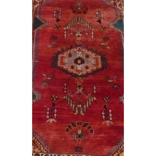 105 - 20th Century Caucasian pattern rug, red ground with stylized central medallion and geometric and flo... 
