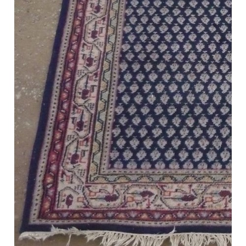 112 - 20th C traditional pattern rug, blue ground with beige and red geometric pattern border, 152cm x 210... 
