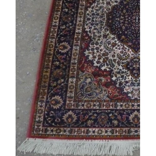 115 - Silk style rug with central medallion and blue ground floral patterned border, 100cm x 150cm