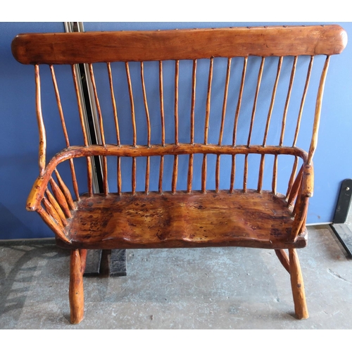 223 - Country made rustic two seat bench, with solid top rail, stick back and shaped seat, on out-splayed ... 