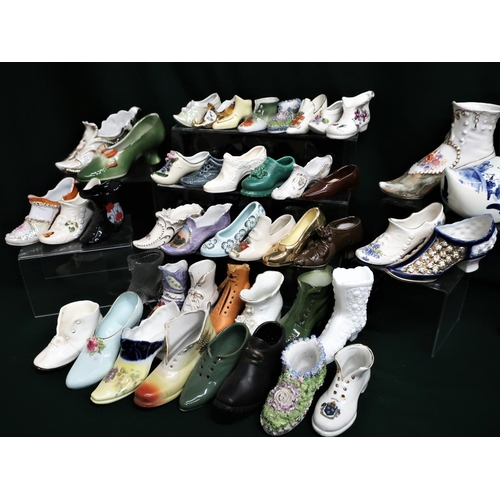 135 - Collection of miniature porcelain shoes, some of modern style and some of earlier fashions (2 boxes)