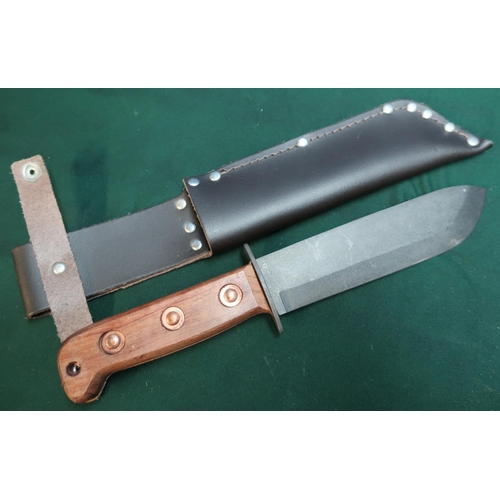 27 - Military style sheath knife with blackened 6.5 inch blade marked 4240-99-127-8214 J Adams 1999, with... 