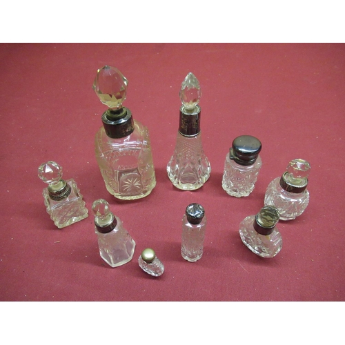 129 - Collection of early 20th C and later cut glass scent bottles, with silver hallmarked collars and top... 