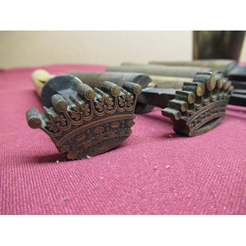 109 - Seven wooden mounted hand blocks set with coronets, two small printing blocks, a horn beaker etc