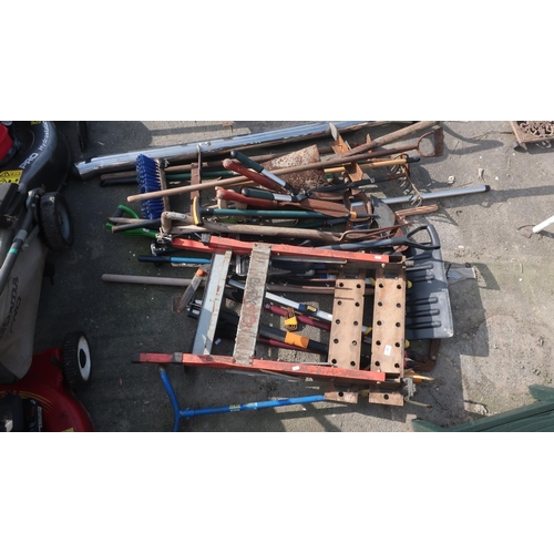 20 - Large collection of garden tools including spades, hoes, racks, work bench, shears, brush, forks, sa... 