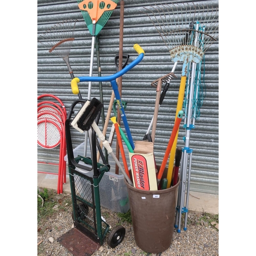 495 - Large collection of garden tools including spades, grass rakes, scarifier, forks, shears, four wheel... 