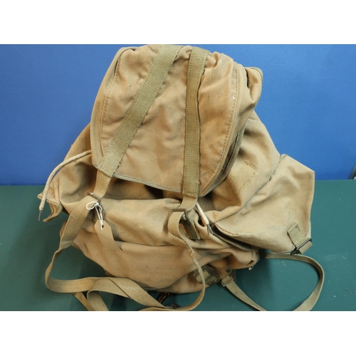 24 - Mid 20th C military style canvas and webbing backpack with metal frame and leather strapworks with i... 