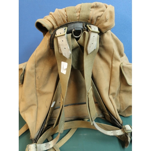 24 - Mid 20th C military style canvas and webbing backpack with metal frame and leather strapworks with i... 