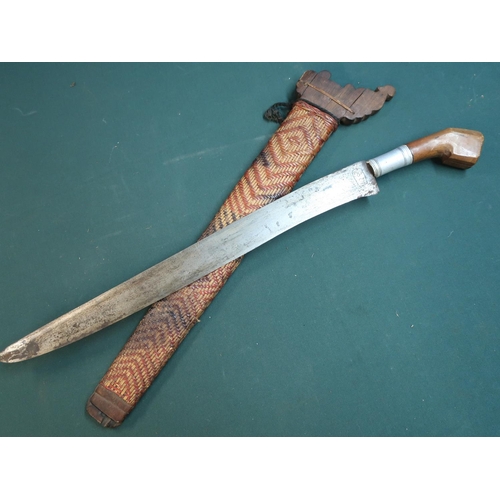 26 - Indonesian style short sword with 18 inch single edged blade with various engraved markings, with wo... 