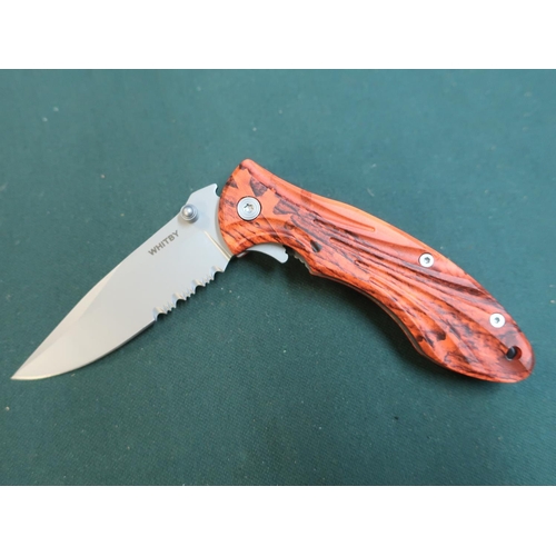 192 - Whitby pocket knife with partial serrated blade and hard plastic orange coloured handle and belt cli... 