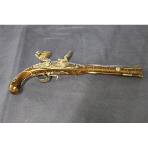 100 - Eastern style flint lock pistol with 11inch octagonal form barrel with flared muzzle and traces of e... 