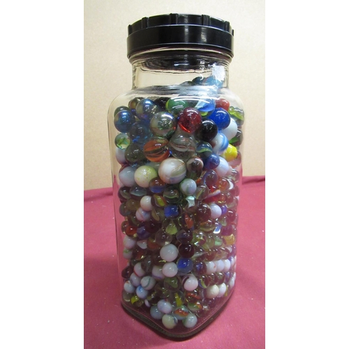 56 - Confectioners glass storage jar containing a selection of marbles of different designs and sizes
