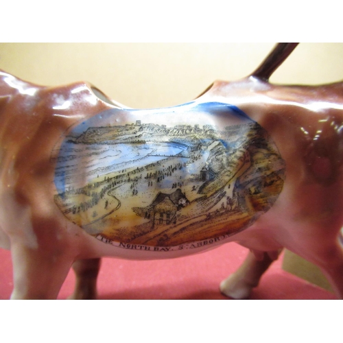 150 - Unusual Scarborough souvenir cow creamer printed with a colour view of the North Bay, Scarborough in... 