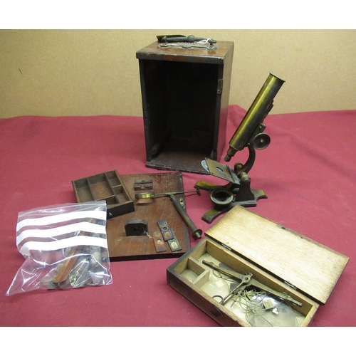 32 - Late 19th C lacquered brass and japanned metal monocular microscope with three slides, bullseye cond... 