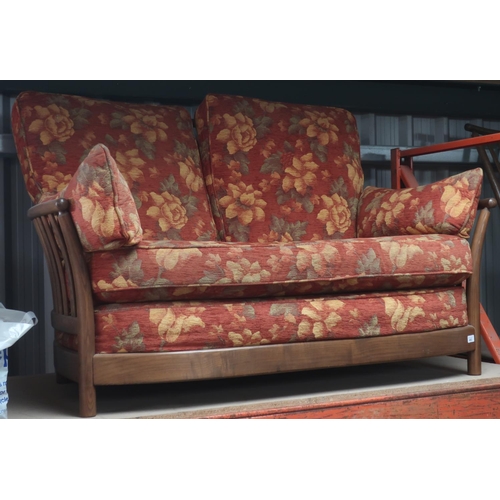 492 - Ercol Renaissance ash-framed two-seater settee with loose rust ground floral patterned cushions appr... 