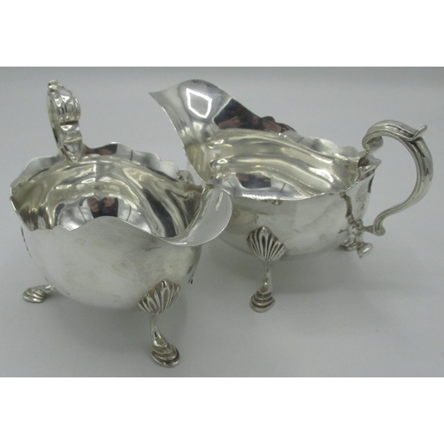 1082 - Pair of Geo.111 style hallmarked silver sauce boats with waived edges, C scroll handles and on shell... 