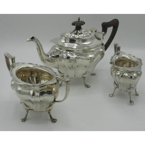 1083 - Geo.V hallmarked silver three piece tea service, with lobed ovoid bodies on four paw feet, tea pot w... 
