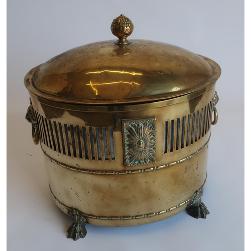 1252 - Regency style brass oval fuel bin, vented body with lion mask and ring handles, domed cover with lea... 