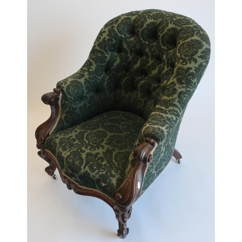 1299 - Victorian walnut framed armchair, with deep buttoned back, scroll carved arm supports on Rococo cabr... 
