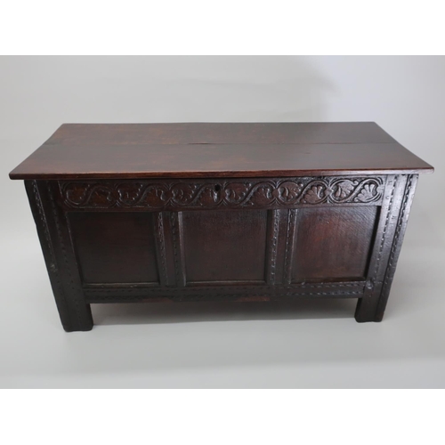 1281 - 18th Century  oak coffer, later planked top above panelled front with stylised leaf carved freize an... 