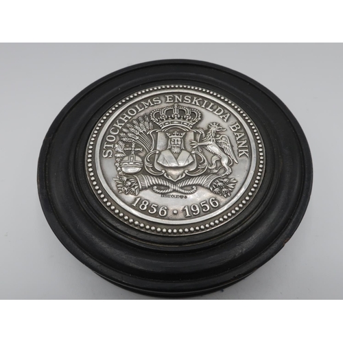 1074 - Stockholms Enskilda Bank 1856-1956 Centenary silver medallion set in a circular ebonised wood paperw... 