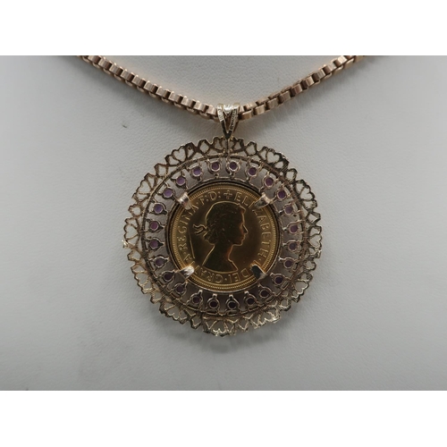 1142 - ER.ll Sovereign 1967, in 9ct hallmarked gold pierced and amethyst set loose mount, on 9ct box chain,... 