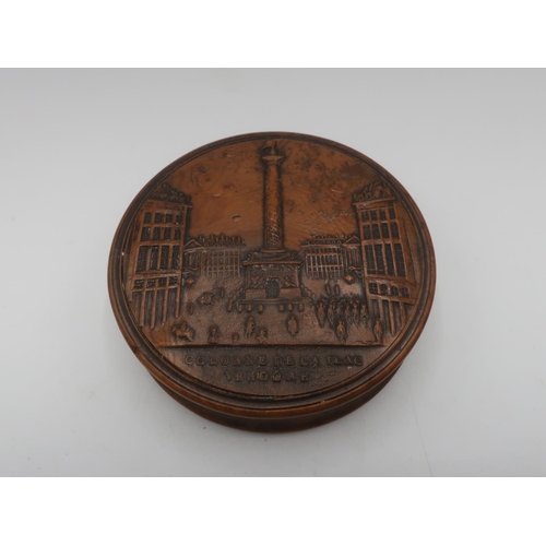 1152 - 19th C French burr maple circular snuff box, the lid pressed with a view of the Colonne De La Plac V... 