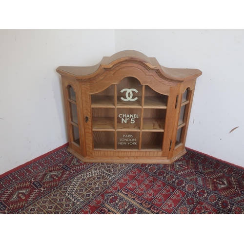 510 - Light oak arched top display cabinet decorated with Chanel No5 Paris London and New York decals, H65... 