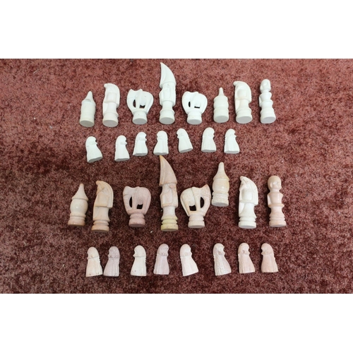 32 - Unusual African carved stone chess set (lacking one pawn)