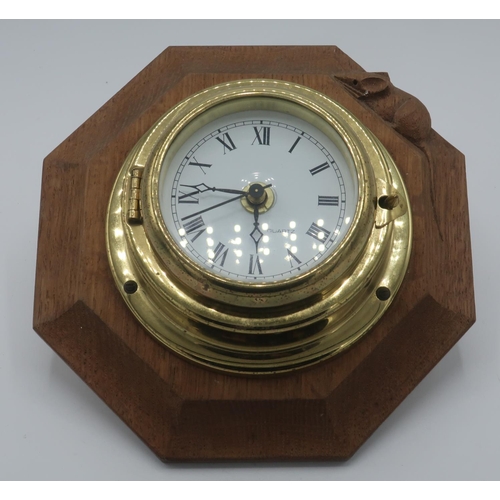 1010 - Robert Mouseman Thompson - a bulkhead type brass wall clock on octagonal backplate, carved with sign... 