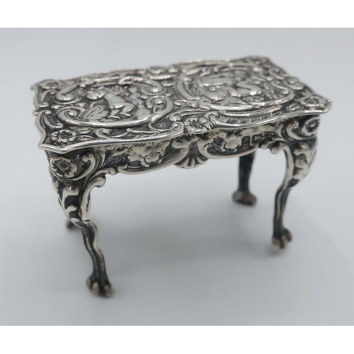 1103 - Late Victorian hallmarked silver miniature centre table, shaped rectangular top repousse with cherub... 