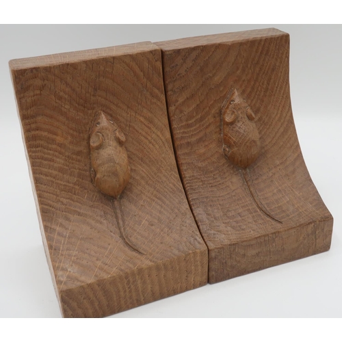 1007 - Robert Mouseman Thompson - a pair of adzed oak book ends of curved form, carved with signature mouse... 