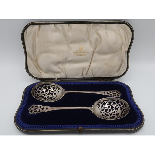 1108 - Pair of Edw.V11 hallmarked silver fruit spoons, scroll pierced bowls with cast shell backs, scroll c... 