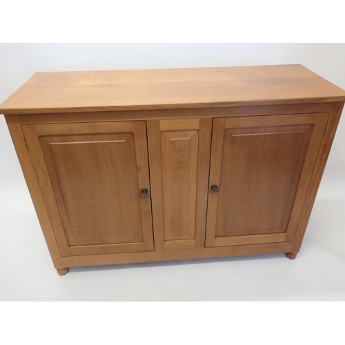 1060 - Andrew Conning Butterfly Furniture - an oak low dresser, with two fielded panelled doors on faceted ... 