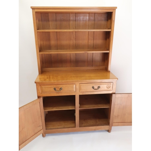 1059 - Andrew Conning Butterfly Furniture - an oak dresser with twin shelf back, the base with panelled dra... 