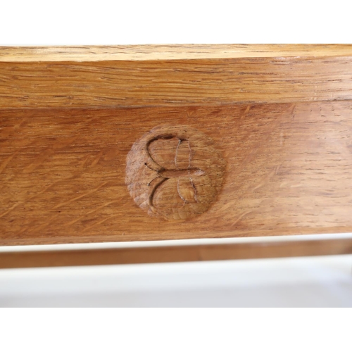 1064 - Andrew Conning Butterfly Furniture - an oak coffee table, with moulded rectangular top on baluster t... 