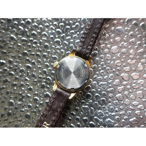 1127 - Ladies Bucherer hand wound wristwatch, gold plated case on leather strap, screw on stainless steel b... 