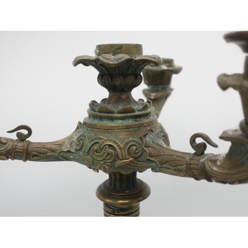 1246 - Pair of Regency gilt bronze candleabra, three scroll branches with leaf cast sconces on anthemion co... 