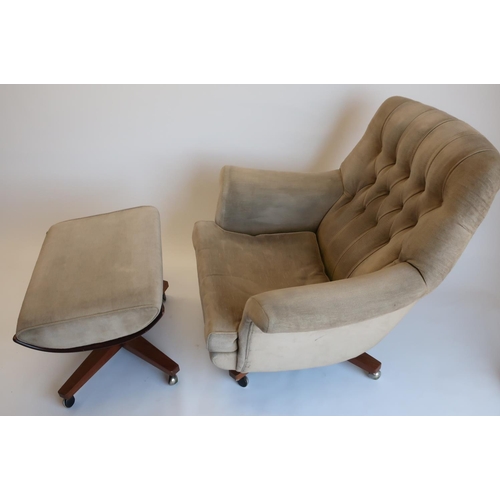 1282 - Mid century G-Plan upholstered swivel arm chair, with buttoned back, outswept arms and loose seat cu... 