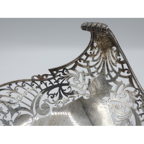 1107 - Geo.V hallmarked silver pierced oval fruit bowl, with oversailing leaf cast scroll handles, on scrol... 