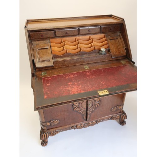 1345 - 1940's oak bureau, galleried top above a fall front with slide out stationary compartments and ink w... 