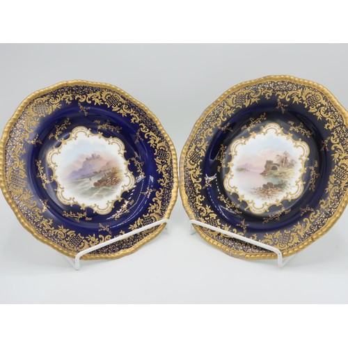 1239 - Pair of Coalport circular cabinet plates, painted to centre with studies of Bamborough and Strancall... 