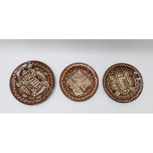 1241 - Three early 20th Century slip ware chargers, white slip decorated with geometric designs, D57cm max ... 