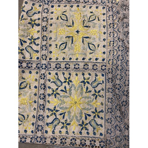 1167 - Hand made table cloth, comprising eighteen panels worked with yellow and blue embroidered flowers an... 