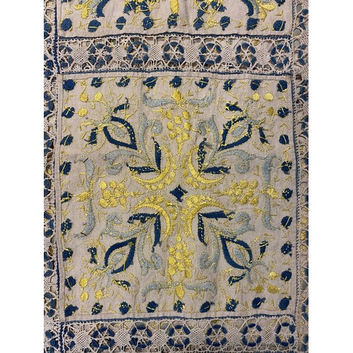 1167 - Hand made table cloth, comprising eighteen panels worked with yellow and blue embroidered flowers an... 