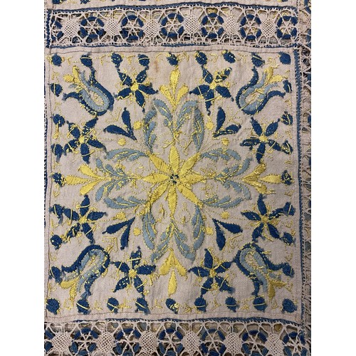 1167 - Hand made table cloth, comprising eighteen panels worked with yellow and blue embroidered flowers an... 