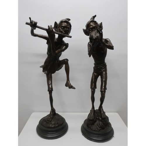 1350 - Pair of brown patinated bronze models of musician Pixies, one playing a flute, the other a shell, on... 