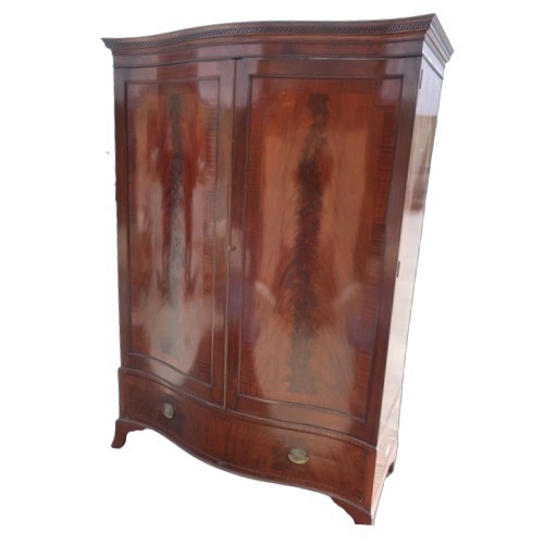 1302 - Geo. III style mahogany serpentine front wardrobe, with Greek key cornice above a pair of  crossband... 