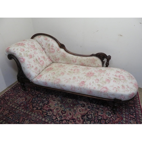 1348 - Victorian mahogany chaise longue, frame carved with flowers and scrolls, on turned tapering supports... 