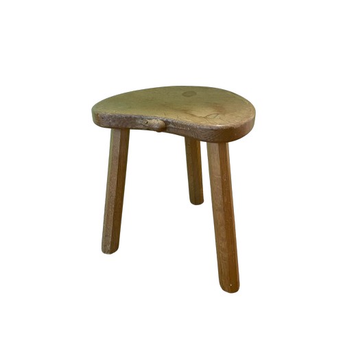 1071 - Robert Mouseman Thompson - an oak Calf stool, adzed kidney shaped top on four faceted outsplayed sup... 